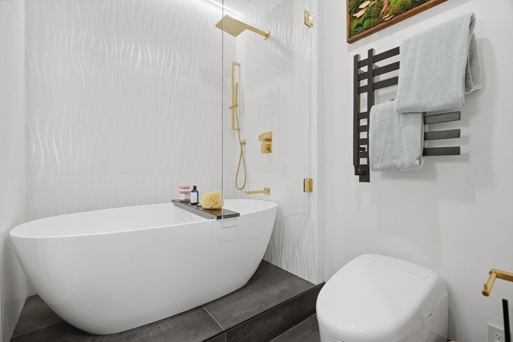 285 Columbus Avenue, Unit PH 805 Boston, MA 02116 - Photo 30 of 42 a white bath tub sitting next to a white toilet