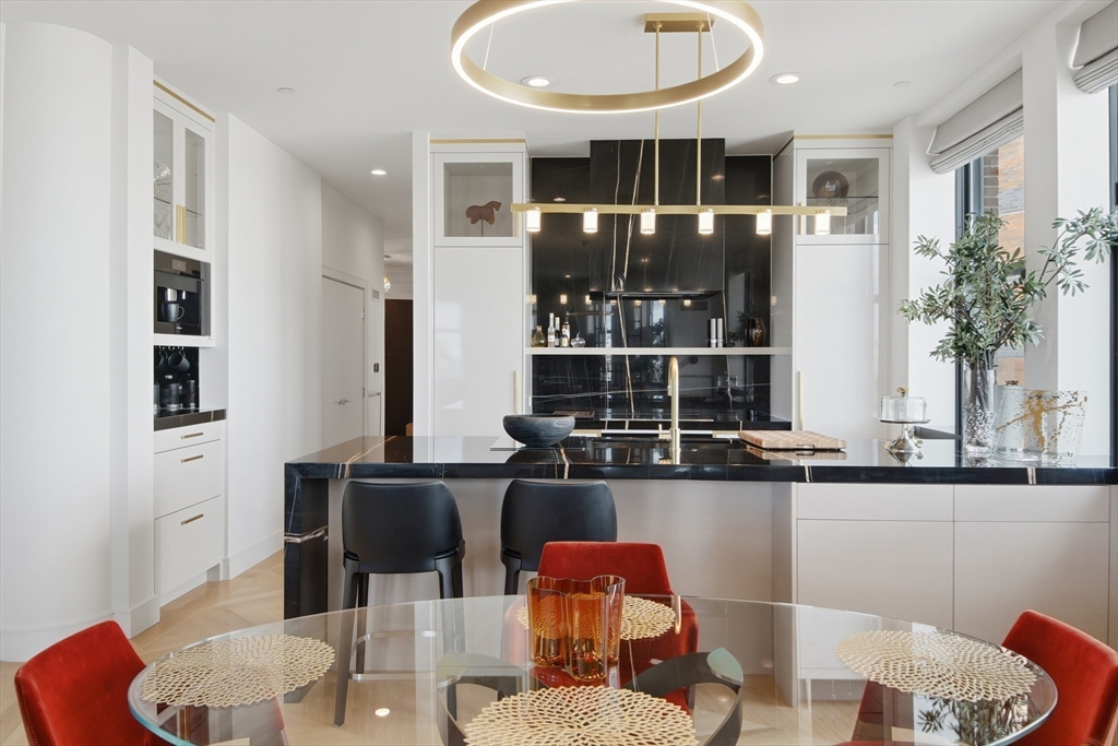 285 Columbus Avenue, Unit PH 805 Boston, MA 02116 - Photo 8 of 42 a dining room with furniture and wooden floor