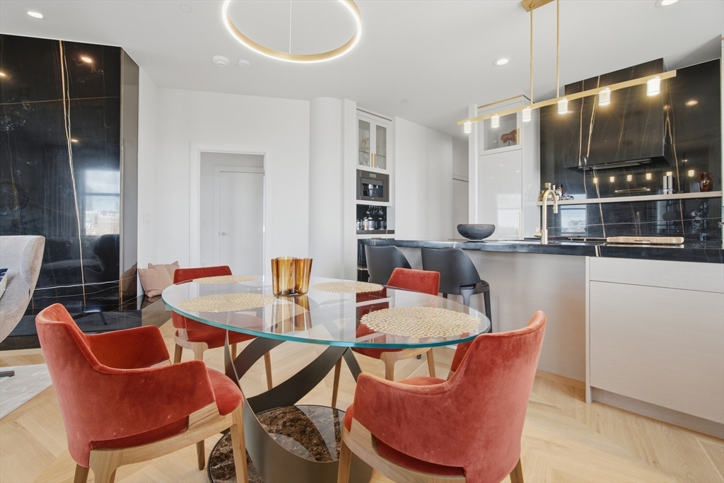 285 Columbus Avenue, Unit PH 805 Boston, MA 02116 - Photo 9 of 42 a dining room with furniture and kitchen view