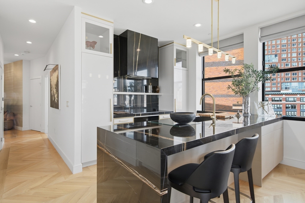 285 Columbus Avenue, Unit PH 805 Boston, MA 02116 - Photo 10 of 42 a dining hall with stainless steel appliances granite countertop a sink and a refrigerator