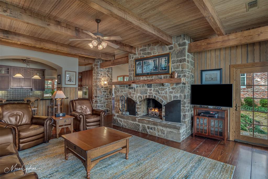 3045 Risinger Drive Shreveport, LA 71119 - Photo 17 of 40 a living room with furniture a flat screen tv and a fireplace