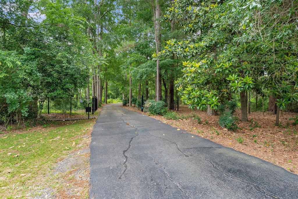 3045 Risinger Drive Shreveport, LA 71119 - Photo 7 of 40 a view of a road with trees in the background