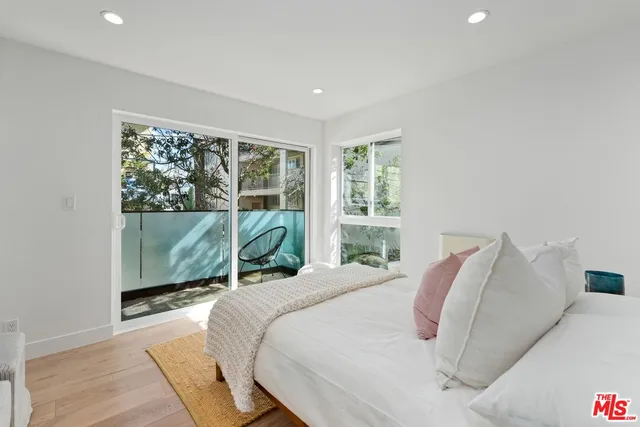 a bedroom with a bed and a large window