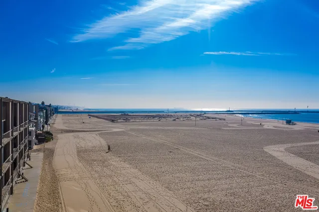 an aerial view of a building with parking and city view