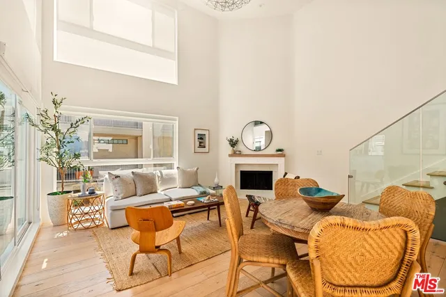 a living room with furniture a fireplace and a table
