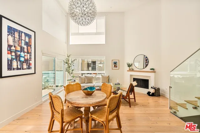 a view of a dining room with furniture and a potted plant