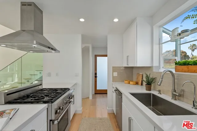 a kitchen that has a sink and a stove