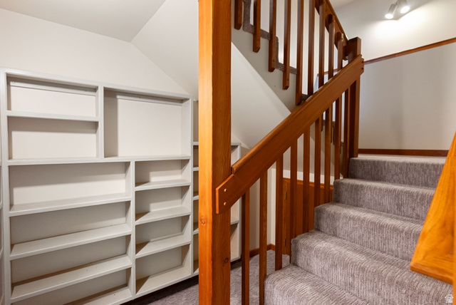 435 Canyon Road Millville, UT 84326 - Photo 37 of 113 Custom built-in shelving and a carpeted staircase with wood railings