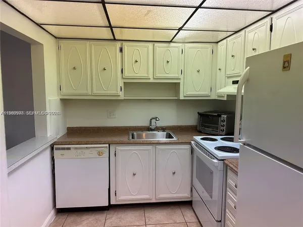 a kitchen with stainless steel appliances granite countertop a sink a stove and refrigerator