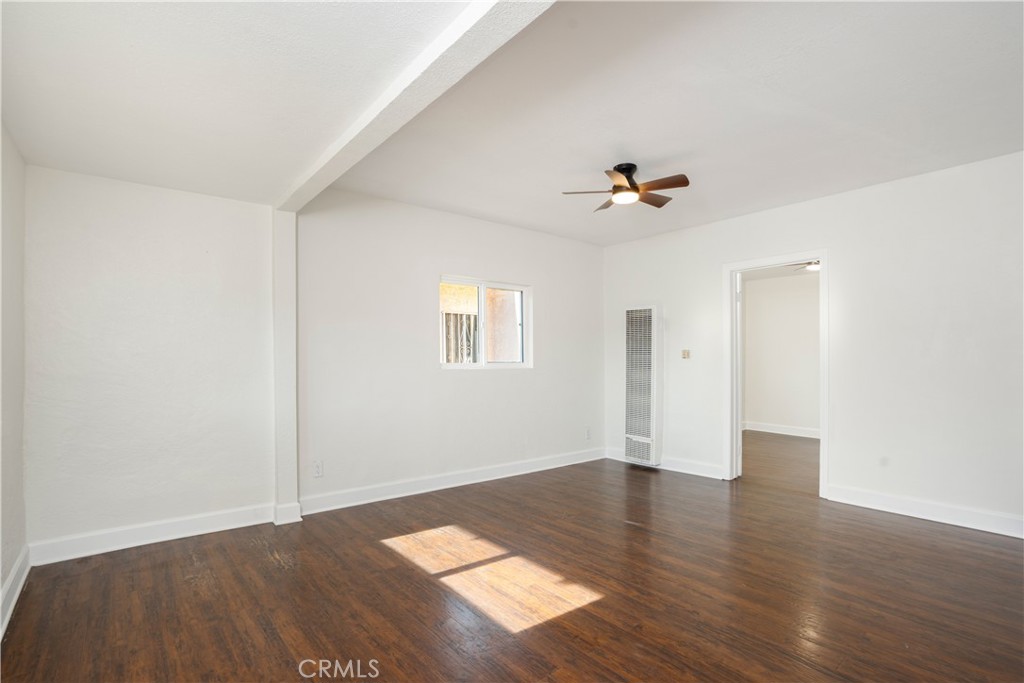 3261 Eagle Street Los Angeles, CA 90063 - Photo 7 of 40 an empty room with wooden floor and a ceiling fan