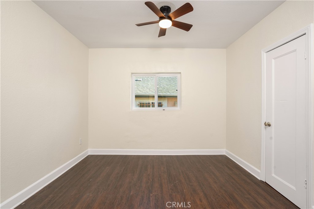 3261 Eagle Street Los Angeles, CA 90063 - Photo 8 of 40 an empty room with wooden floor ceiling fan and window