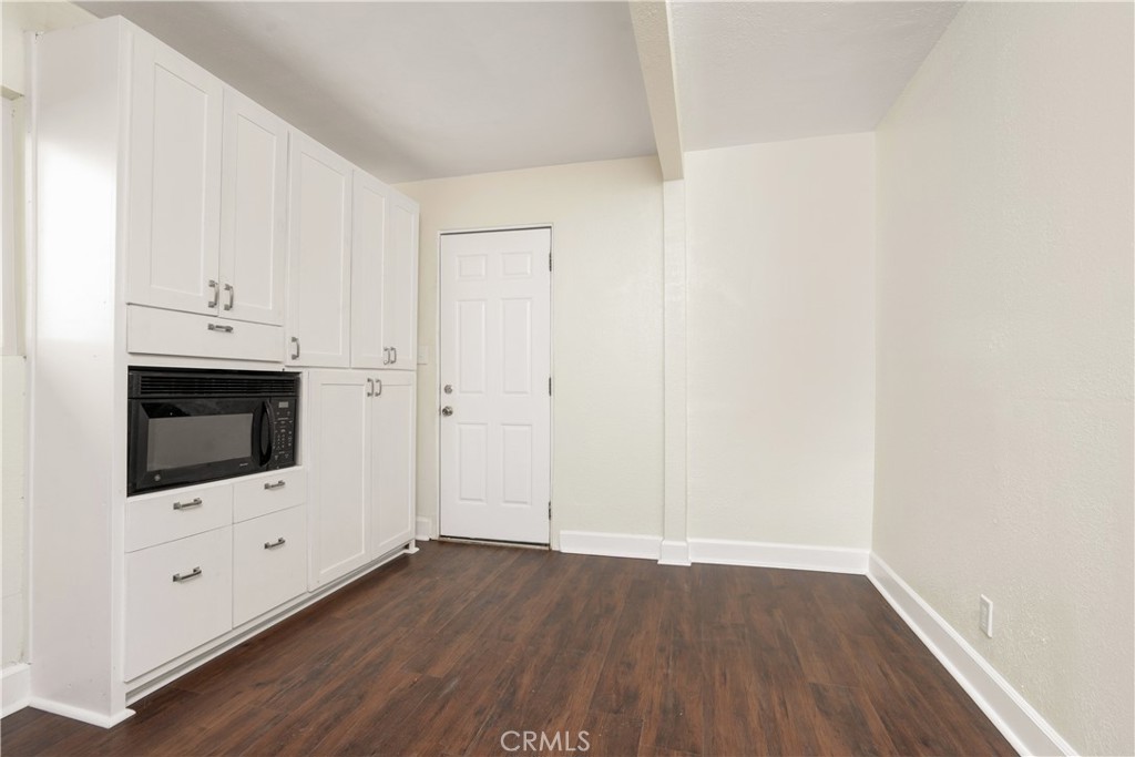 3261 Eagle Street Los Angeles, CA 90063 - Photo 12 of 40 a room with wooden floor and white wall