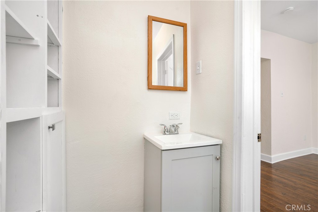 3261 Eagle Street Los Angeles, CA 90063 - Photo 16 of 40 a bathroom with a sink a mirror and wooden floor