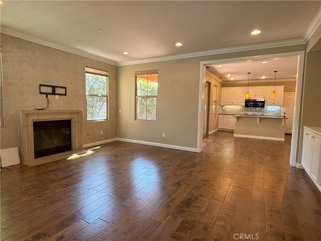 25 Bridge Trail Irvine, CA 92618 - Photo 1 of 25 an empty room with wooden floor and a fireplace