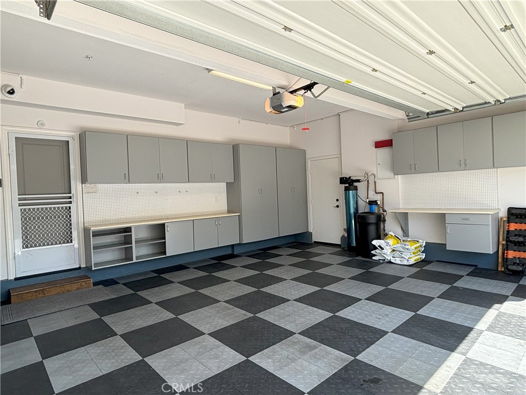 25 Bridge Trail Irvine, CA 92618 - Photo 20 of 25 a garage with a white checkered floor and a fireplace