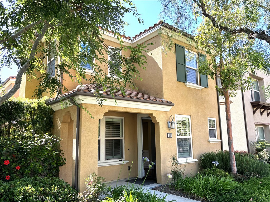 25 Bridge Trail Irvine, CA 92618 - Photo 21 of 25 a view of a white house with a large windows and a tree