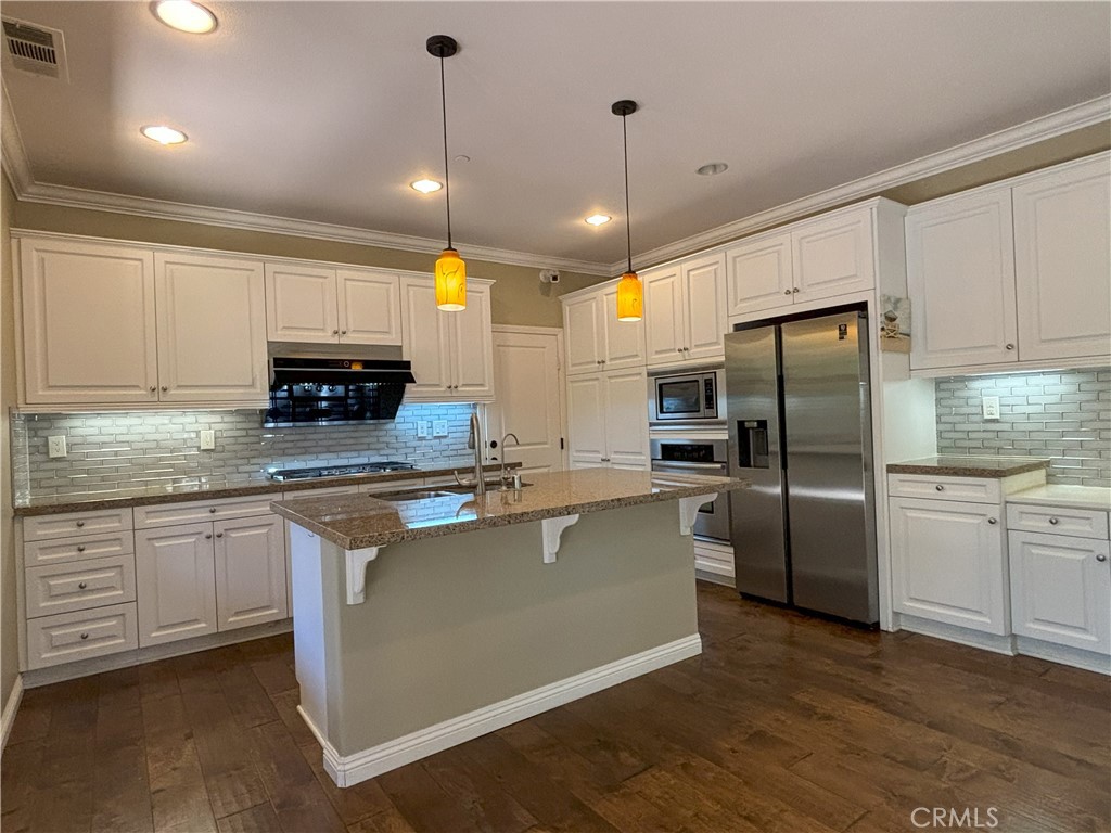 25 Bridge Trail Irvine, CA 92618 - Photo 3 of 25 a kitchen with stainless steel appliances granite countertop a refrigerator a stove a sink and a microwave