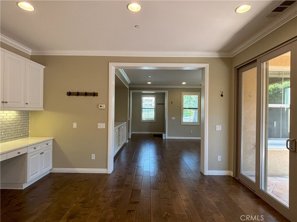 25 Bridge Trail Irvine, CA 92618 - Photo 4 of 25 a view of a hallway with wooden floor and a living room
