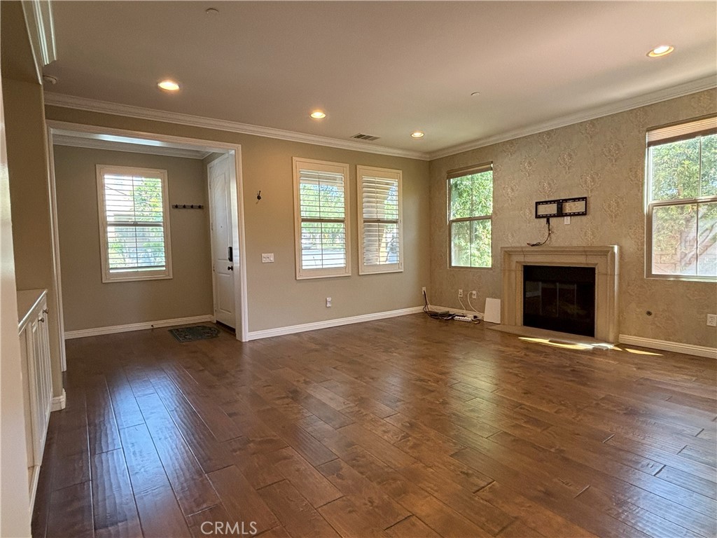 25 Bridge Trail Irvine, CA 92618 - Photo 5 of 25 an empty room with wooden floor and a fireplace