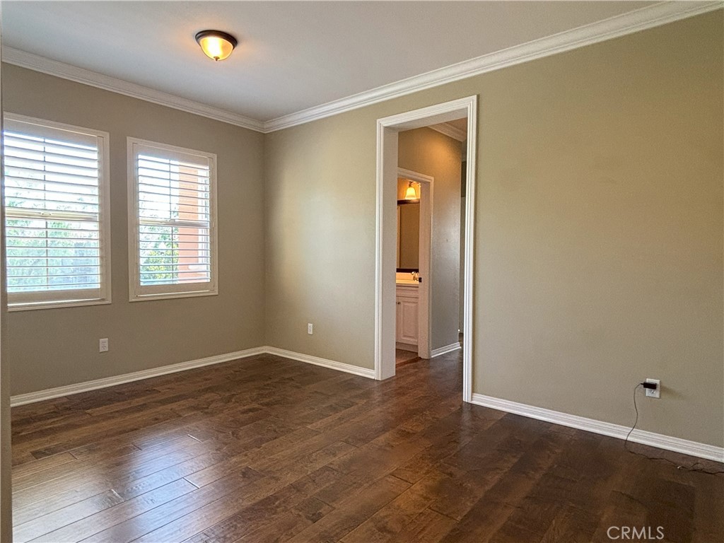 25 Bridge Trail Irvine, CA 92618 - Photo 6 of 25 an empty room with wooden floor and windows