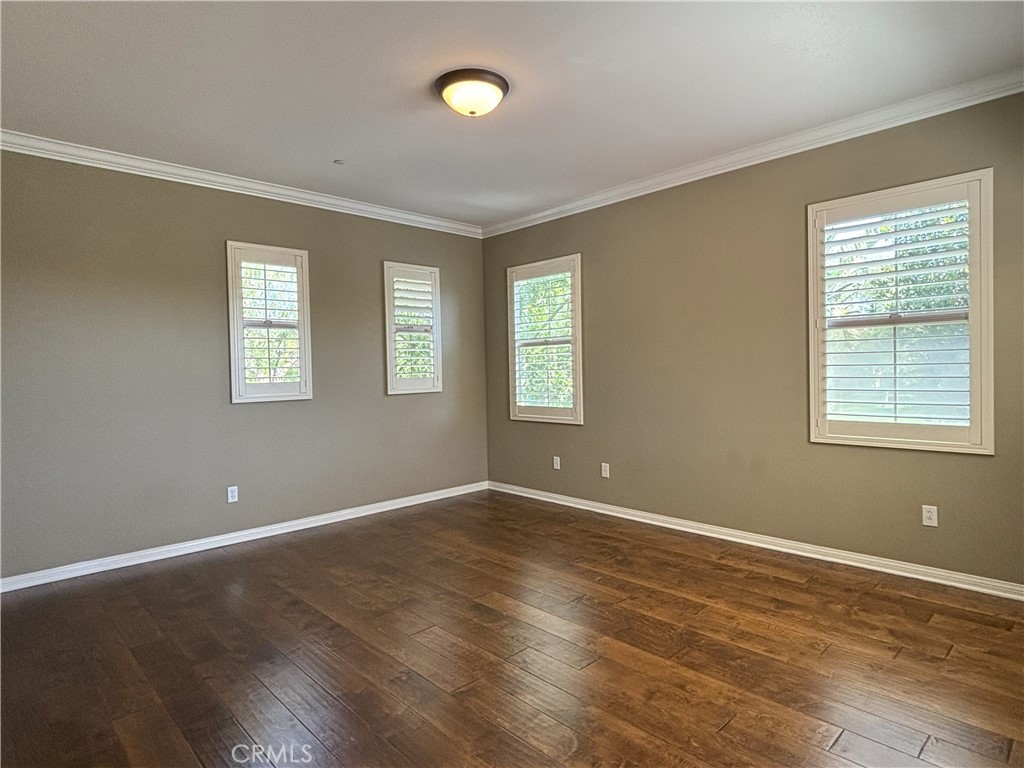 25 Bridge Trail Irvine, CA 92618 - Photo 7 of 25 a view of an empty room with wooden floor and a window