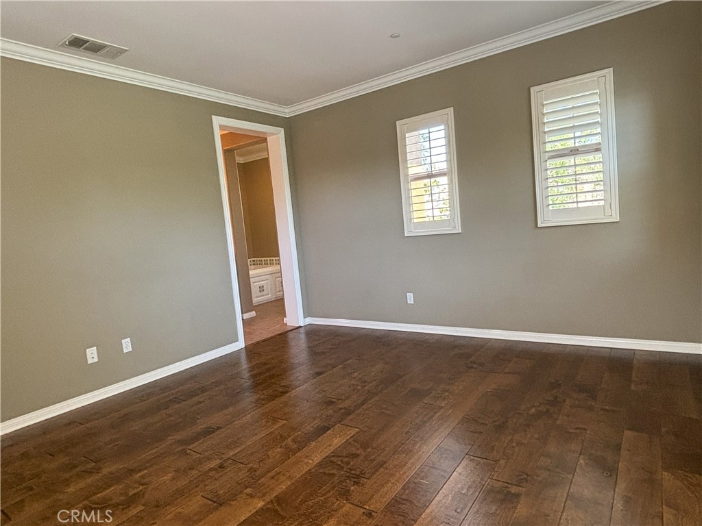 25 Bridge Trail Irvine, CA 92618 - Photo 8 of 25 a view of an empty room with wooden floor and a window