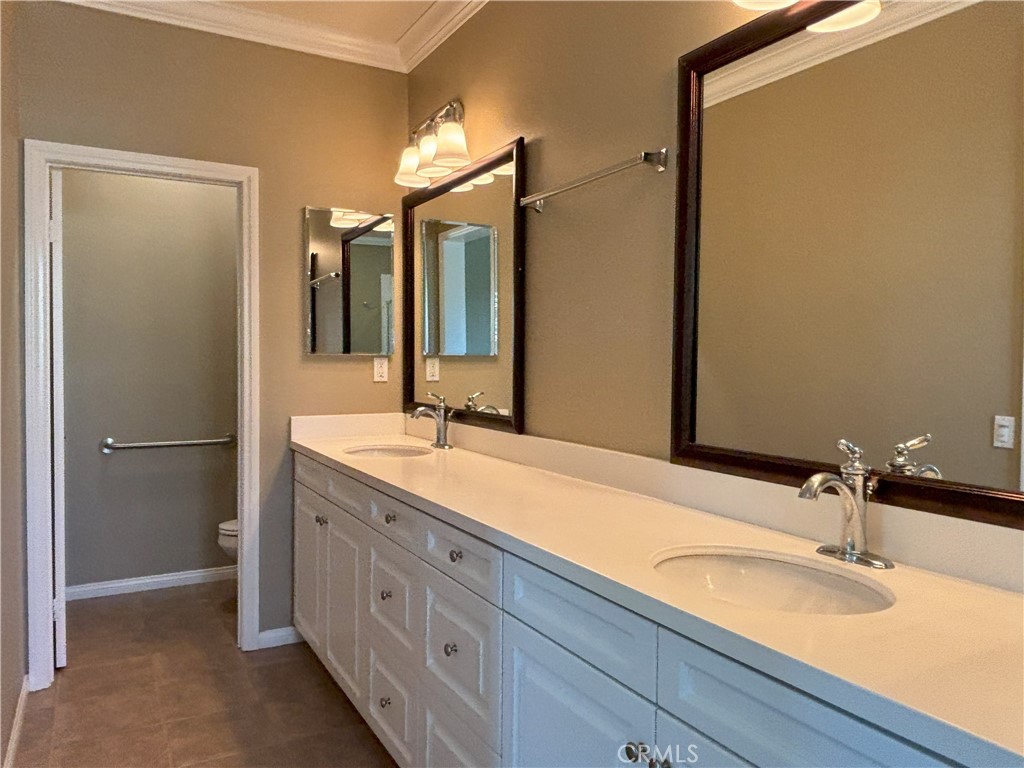 25 Bridge Trail Irvine, CA 92618 - Photo 9 of 25 a bathroom with a granite countertop sink and a mirror