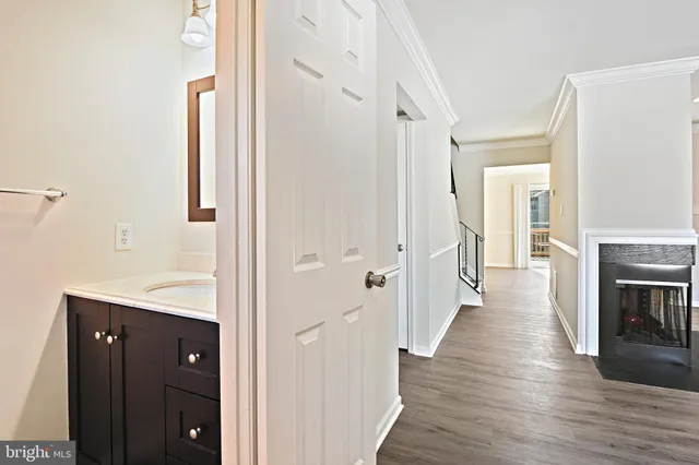 a view of a hallway with wooden floor and staircase