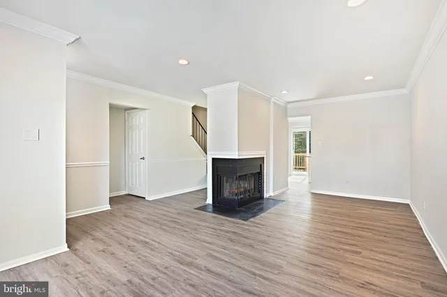 a view of empty room with wooden floor