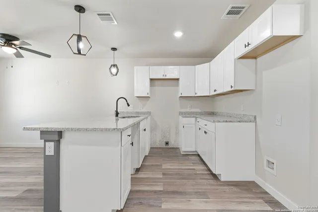 a kitchen with cabinets a sink and dishwasher in it