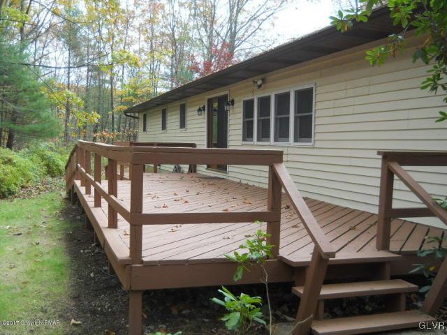 284 Sundance Road Effort, PA 18330 - Photo 4 of 20 a view of a house with wooden deck and a couple