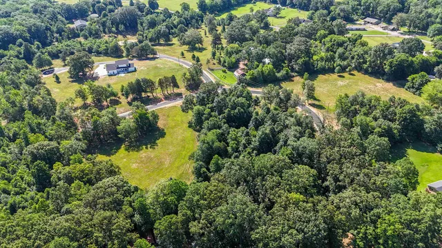 an aerial view of residential houses with yard and swimming pool