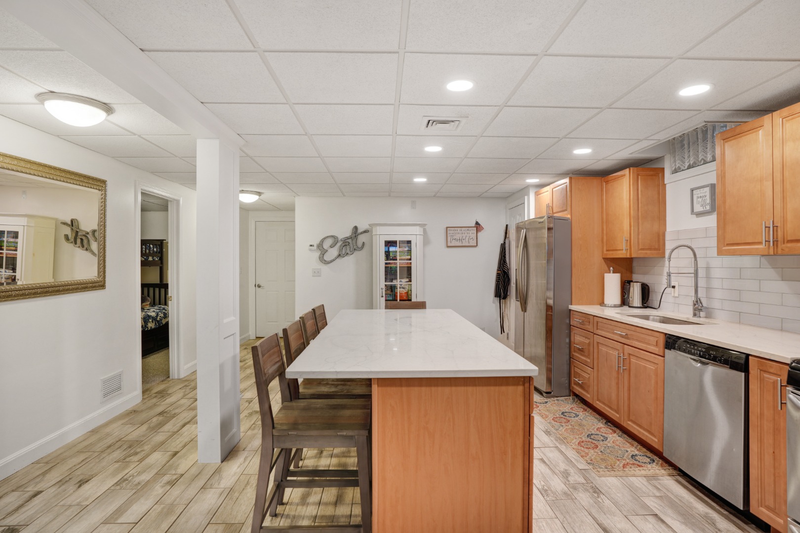 8 Fresh Pond Road Oak Bluffs, MA 02557 - Photo 24 of 36 a kitchen with stainless steel appliances kitchen island granite countertop a refrigerator and microwave