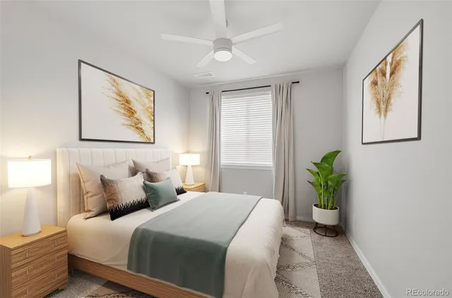 a bedroom with bed and a painting on the wall