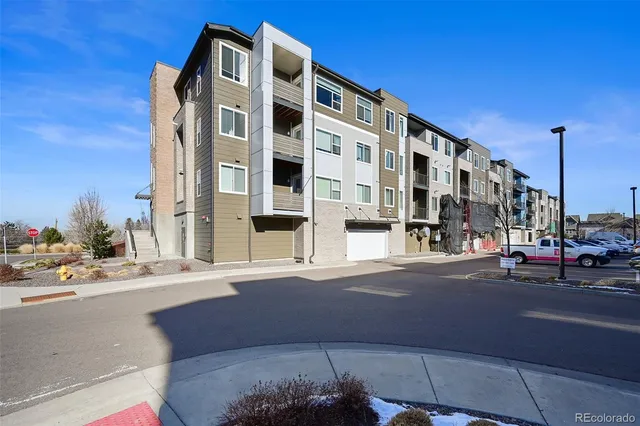 a view of a tall building next to a road