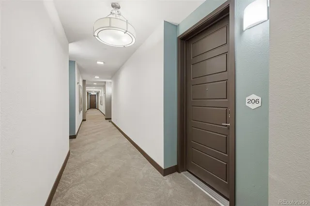 view of a hallway with wooden floor and staircase