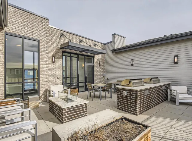 a view of a patio with couches chairs and wooden floor