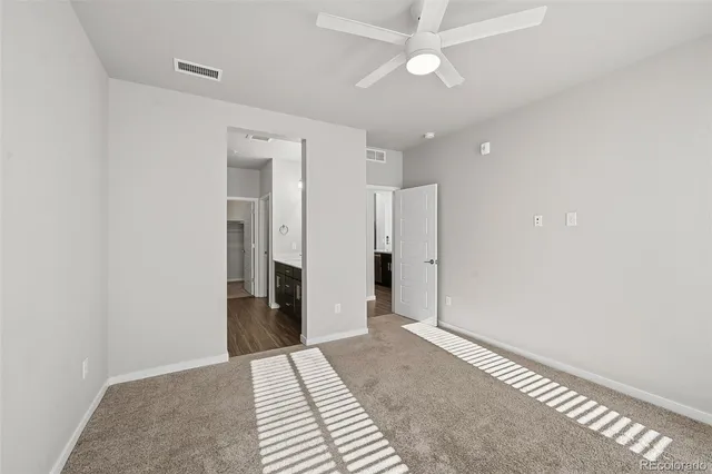 a view of an empty room with a ceiling fan