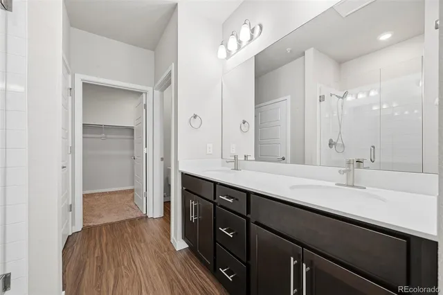 a bathroom with a double vanity sink and mirror