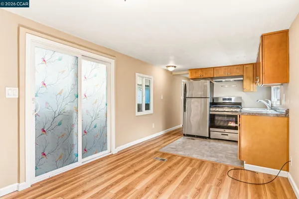 a kitchen with stainless steel appliances granite countertop a refrigerator sink and cabinets