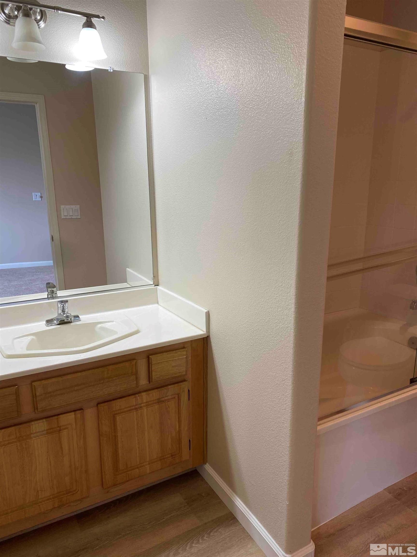 900 S Meadows, Unit 3722 Reno, NV 89521 - Photo 14 of 26 a bathroom with a double vanity sink and a mirror