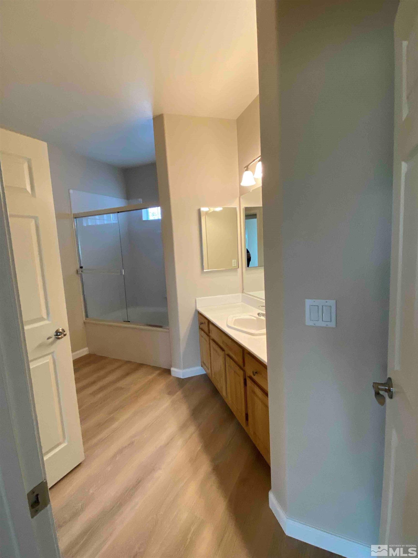 900 S Meadows, Unit 3722 Reno, NV 89521 - Photo 16 of 26 a bathroom with a sink a mirror and a shower