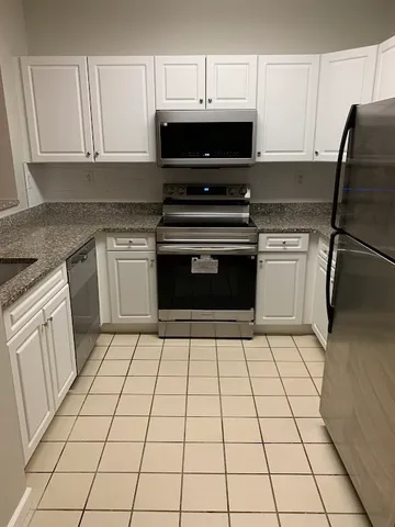 a kitchen with a stove a sink and a microwave