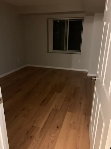 a view of wooden floor and a window