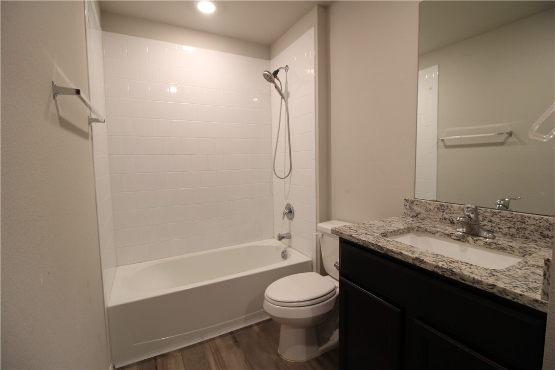 7009 Guadalupe Road China Spring, TX 76633 - Photo 16 of 20 a bathroom with a granite countertop sink toilet and shower