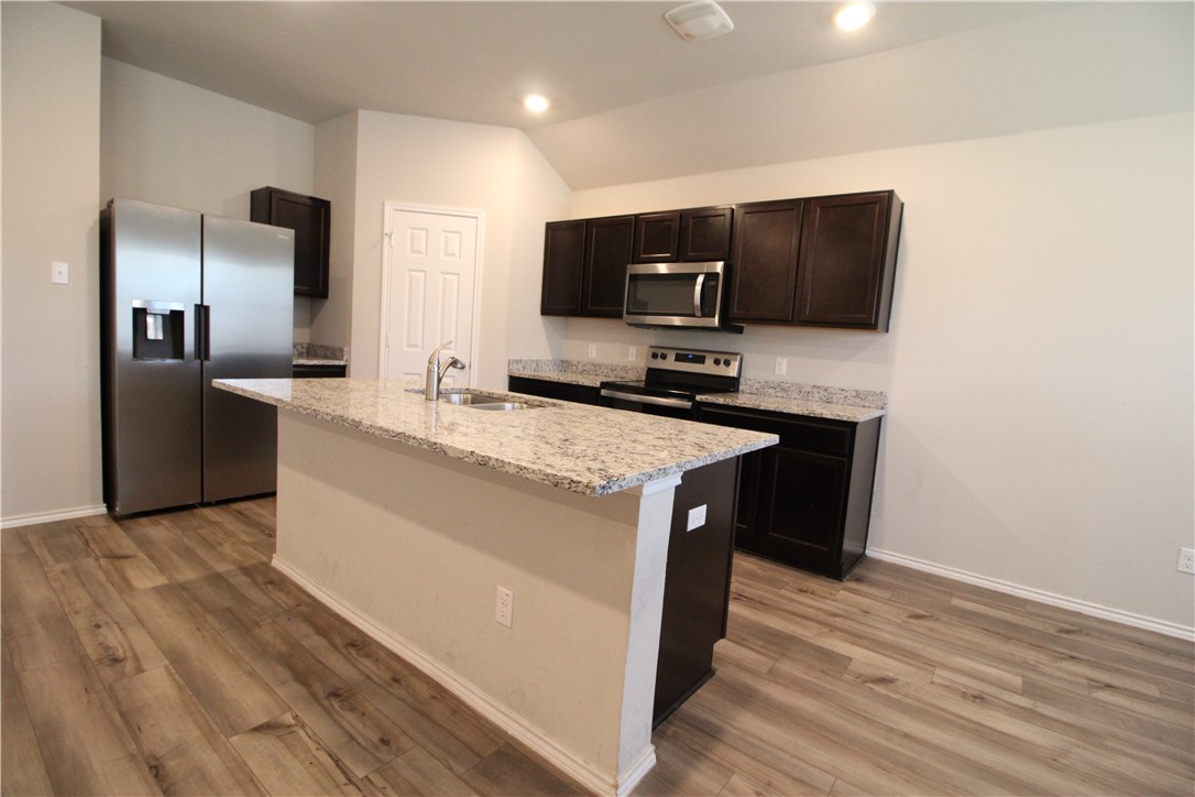 7009 Guadalupe Road China Spring, TX 76633 - Photo 7 of 20 a kitchen with stainless steel appliances a sink and a microwave