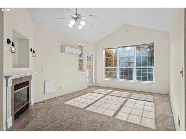 a view of an empty room with a fireplace