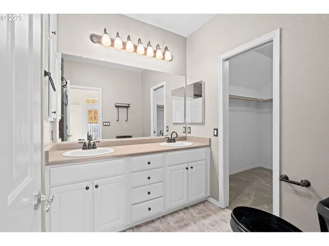 a bathroom with a double vanity sink and a mirror