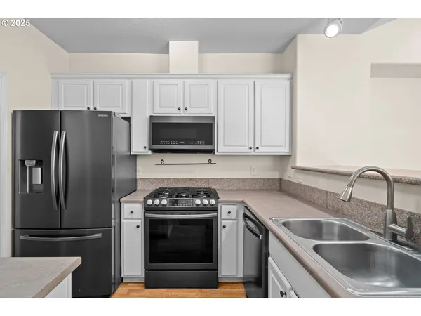 a kitchen with a sink stove and refrigerator