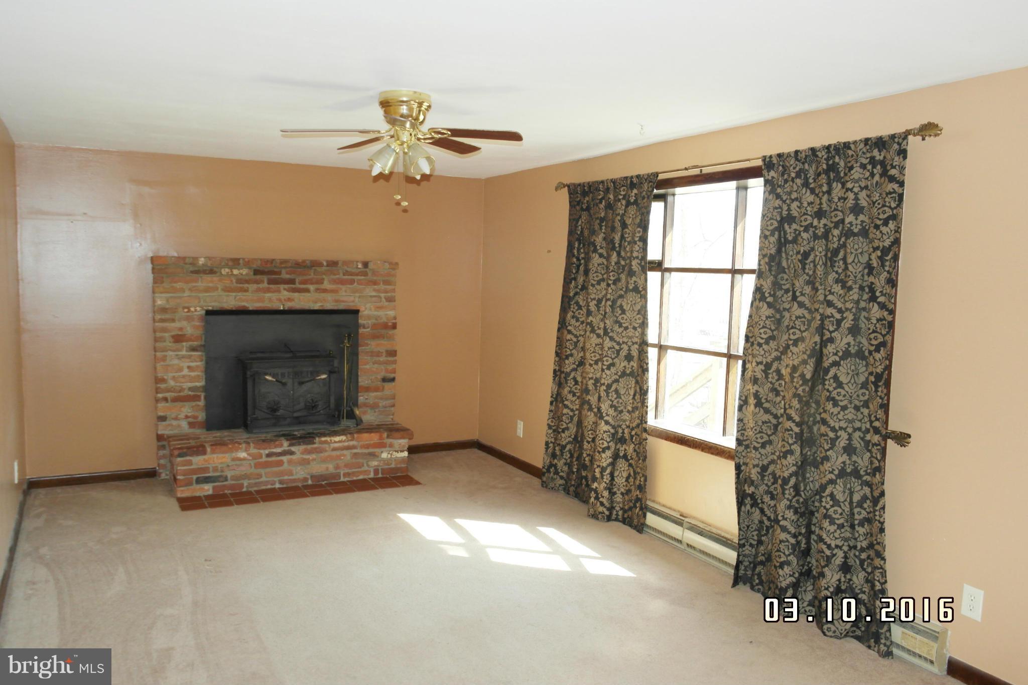 4524 Elmer Derr Road Frederick, MD 21703 - Photo 4 of 15 a living room with furniture and a fireplace